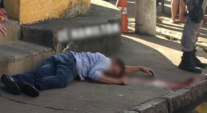 A vítima, identificada como José Amilton Soares da Silva, de 48 anos, estava jogando dama quando um táxi parou no local — © Cortesia