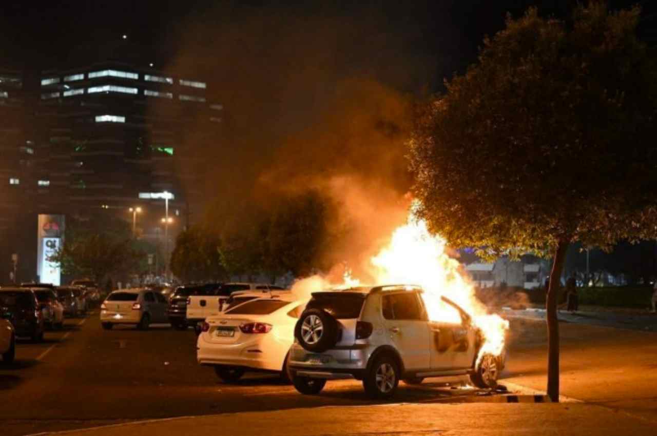 Carro é tomado por chamas de fogo durante a ação criminosa dos manifestantes | © Evaristo Sa / AFP